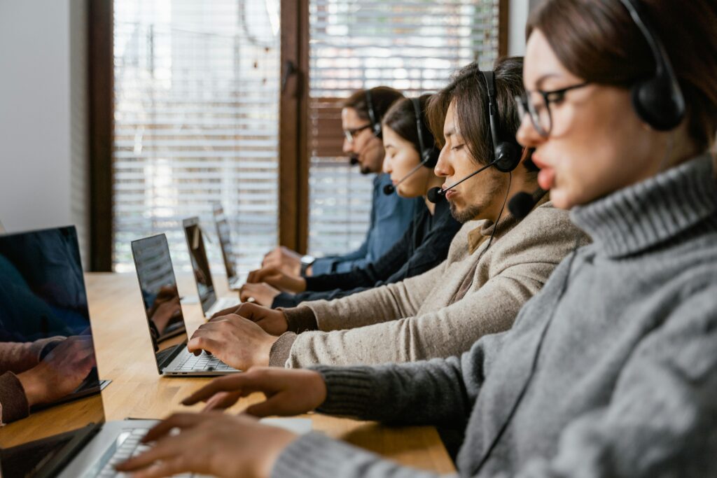 Call center agents wearing headsets conducting phone surveys